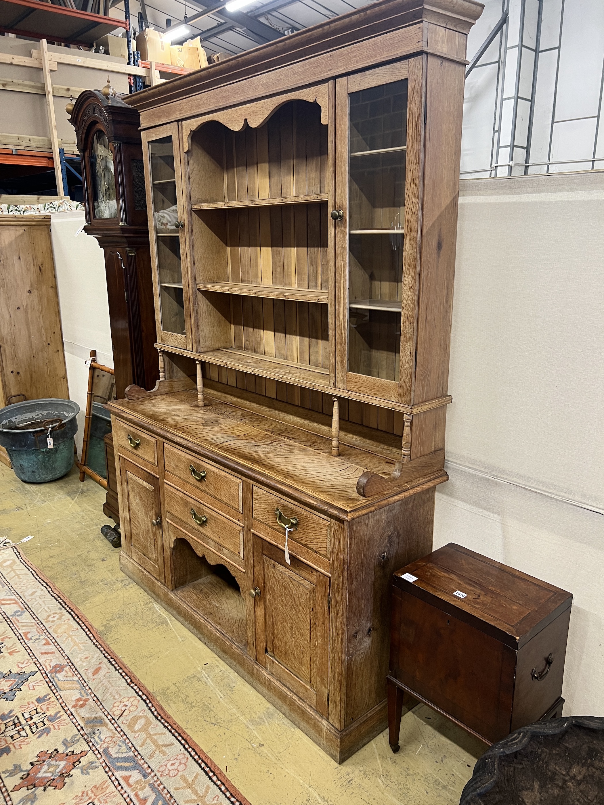 An early 20th century bleached oak dresser, width 165cm, depth 48cm, height 223cm